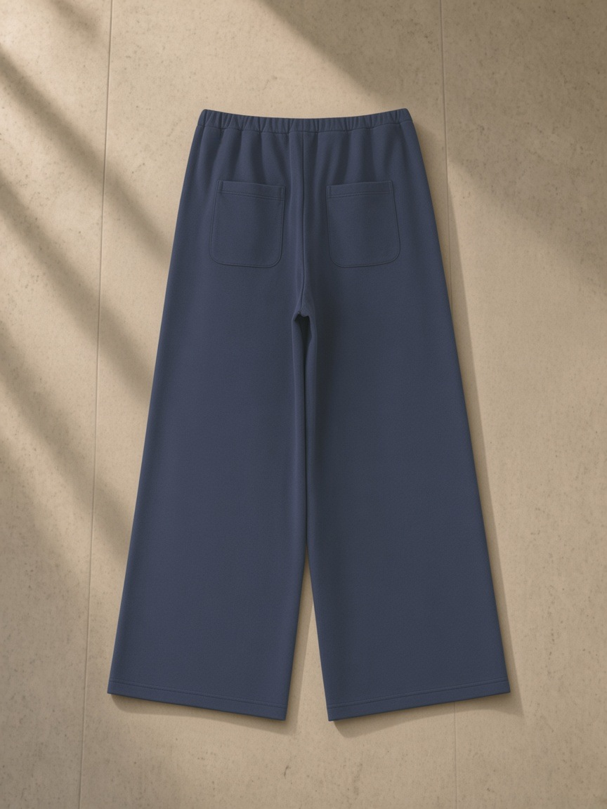 Women's Wide Leg Sweatpants in Navy Blue, laid flat on pale limestone, back.