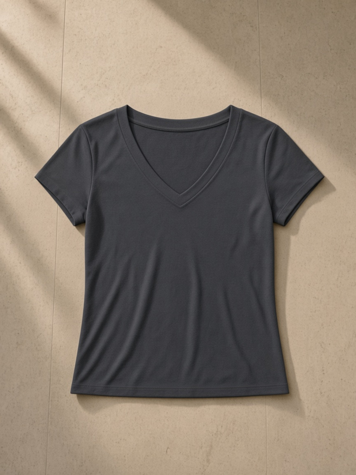 Tencel Slim Fit V-Neck T-Shirt in Dark Gray, laid flat on pale limestone, front.