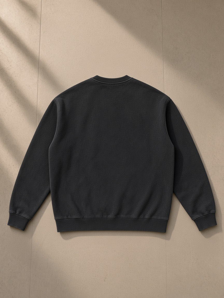 Vintage Washed Fleece Baseball Jacket in Black, laid flat on pale limestone, back view