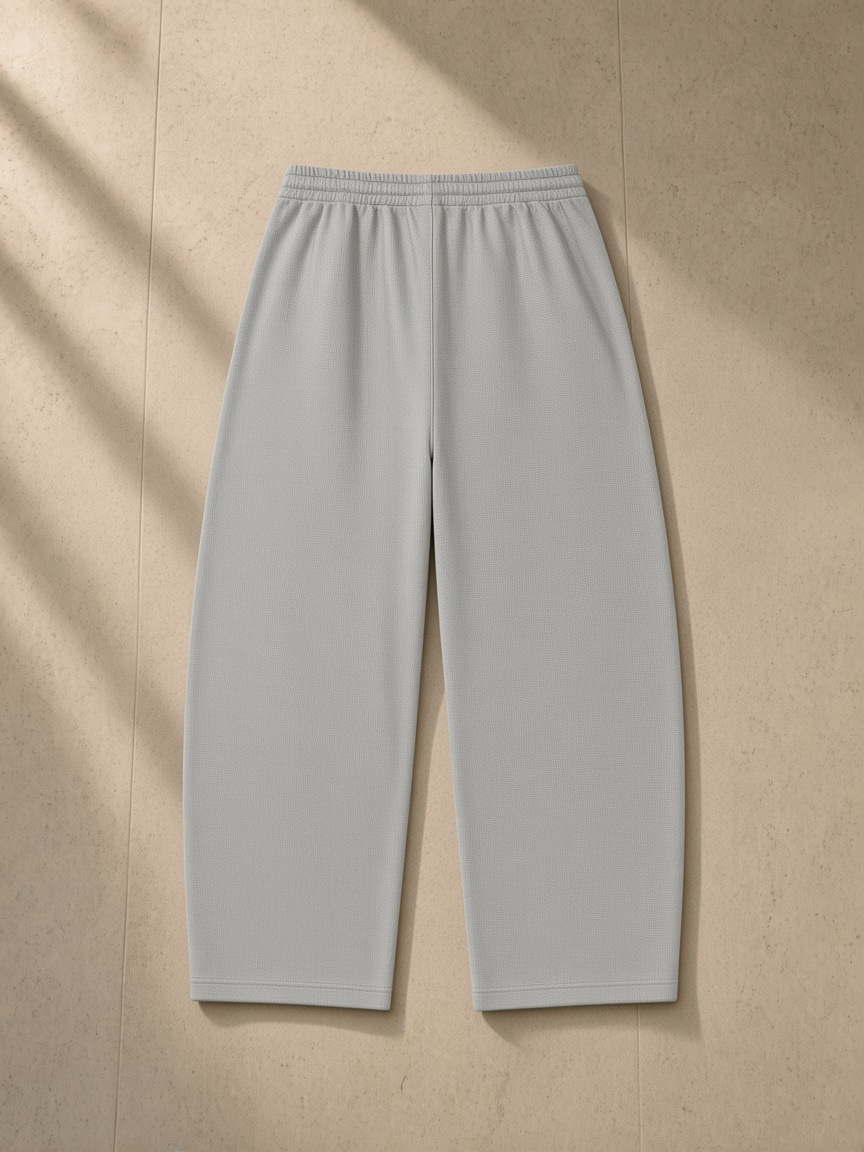 Waffle barrel leg pants in Light Gray, laid flat on pale limestone, back view
