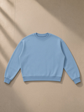 Boxy Vintage Washed Sweatshirt in Light Blue, laid flat on pale limestone