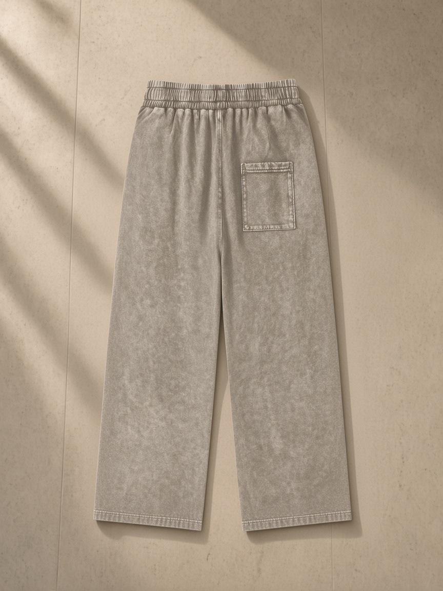 Snow Washed Straight Leg Pants in Stone Gray, laid flat on pale limestone, back.