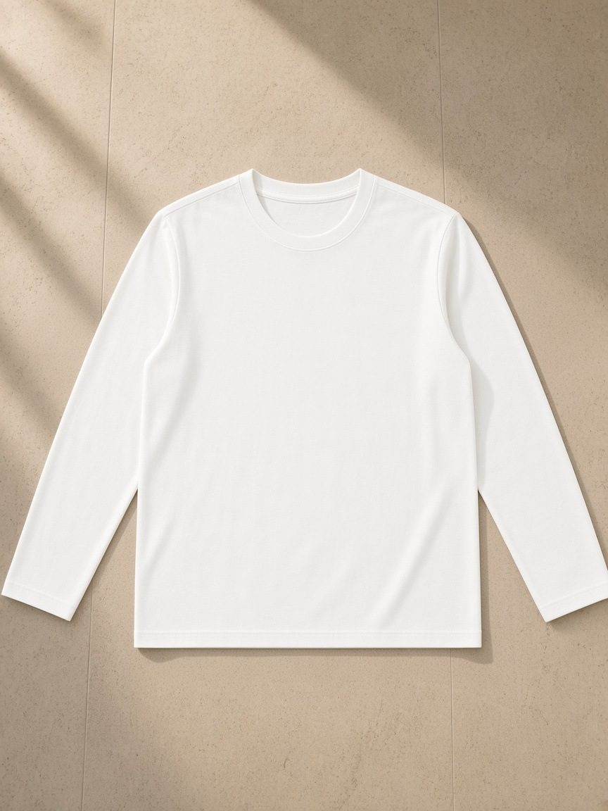 Heavyweight Long Sleeve T-Shirt in White, laid flat on pale limestone