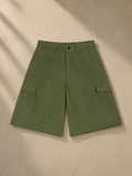 Woven cargo shorts in Army Green, laid flat on pale limestone