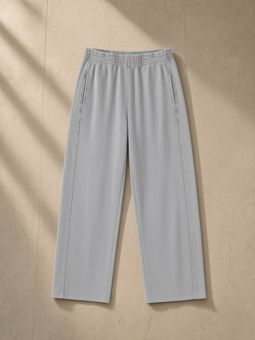 Mineral Wash Straight Sweatpants in Light Gray, laid flat on pale limestone