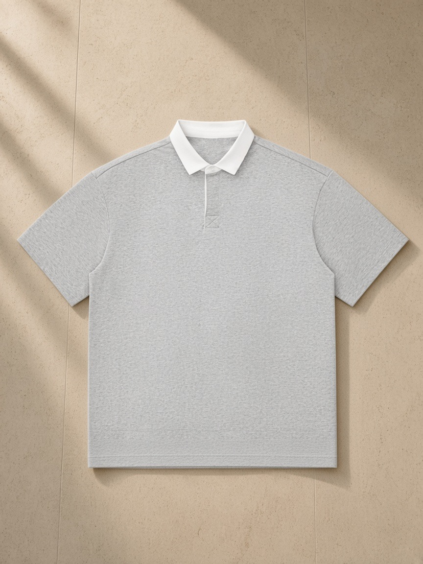 Essential Contrast Polo Shirt in Flower Gray, laid flat on pale limestone