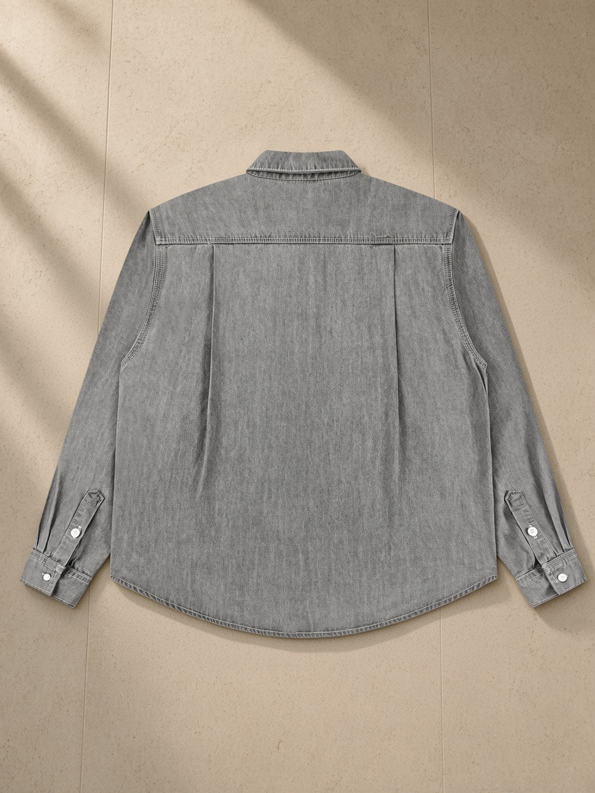 Vintage Wash Denim Shirt in Light Gray, laid flat on pale limestone, back view