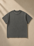 Mineral Wash Waffle Knit T-Shirt in Gray, laid flat on pale limestone