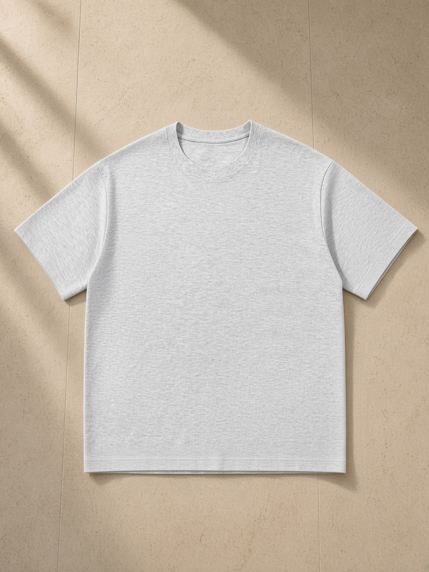 Unisex cotton t-shirt in White Gray, laid flat on pale limestone