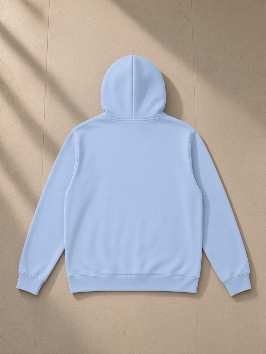 Essential oversized hoodie in Sky Blue, laid flat on pale limestone, back view