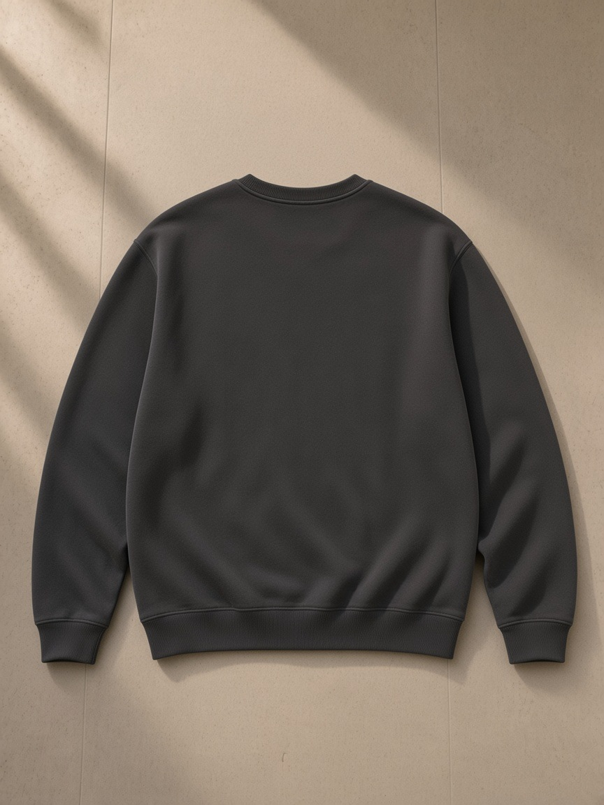 Streetwear Cotton Pullover in Pirate Black, laid flat on pale limestone, back view