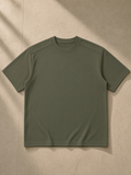 Sorona Quick-Dry Loose Fit Boxy T-Shirt in Army Green, laid flat on pale limestone, front.