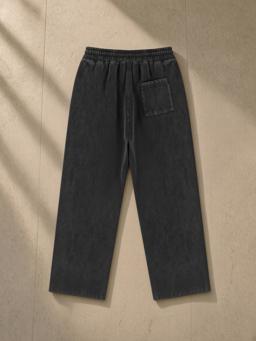 Vintage Wash Fleece Sweatpants in Black, laid flat on pale limestone, back.