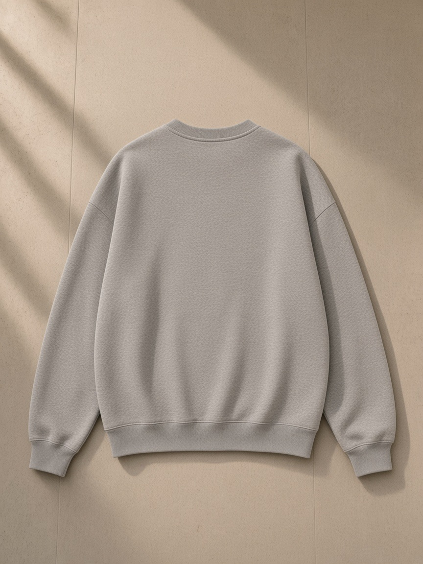 Unisex oversized v-neck sweatshirt in Flower Gray, laid flat on pale limestone, back view