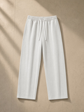 Vintage wash fleece sweatpants in Light Gray, laid flat on pale limestone