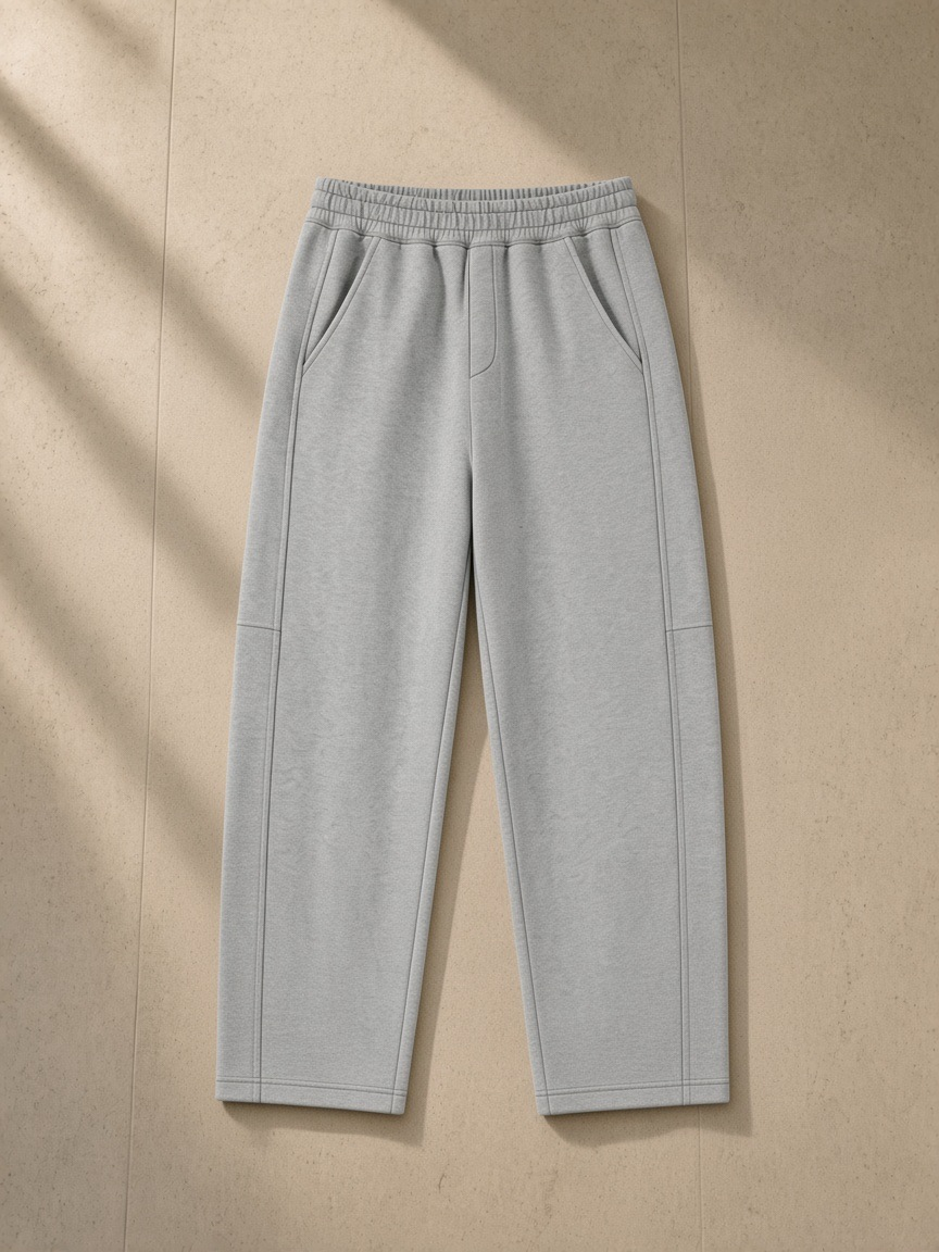 Tapered straight hem sweatpants in Flower Gray over a leather armchair in a Utah desert suite at night