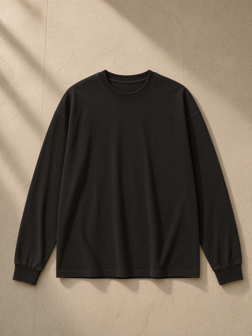 Vintage Washed Long Sleeve T-Shirt in Vintage Black, laid flat on pale limestone