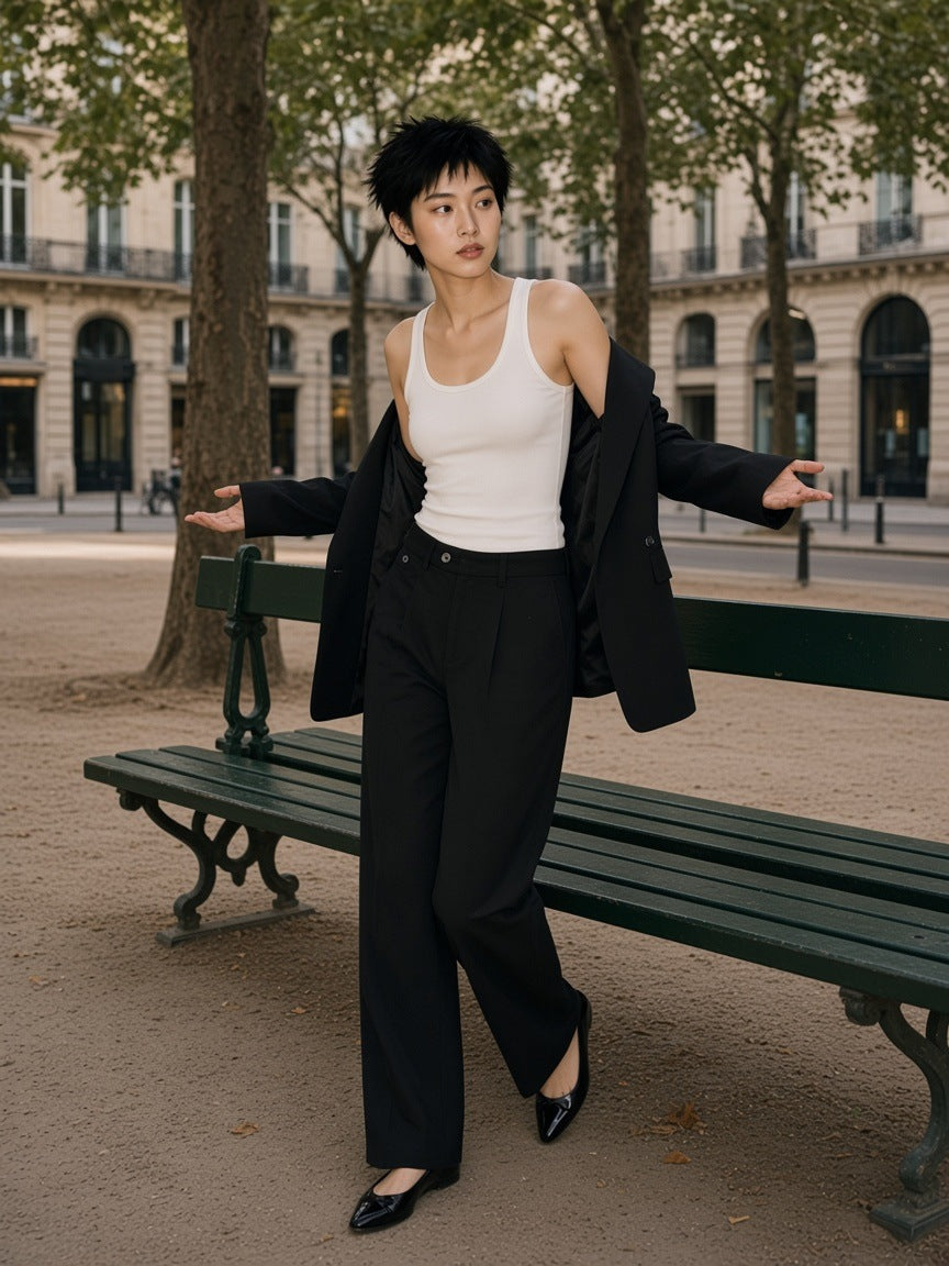 Woman in the Adjustable Waist Straight-Leg Trousers in Black, by a bench in Place Dauphine, Paris in the morning