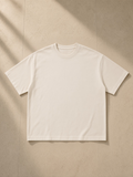 Unisex vintage wash boxy t-shirt in Apricot, laid flat on pale limestone