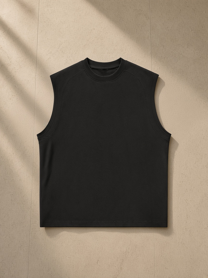 Sorona Quick-Dry Cooling Tank Top in Black, laid flat on pale limestone
