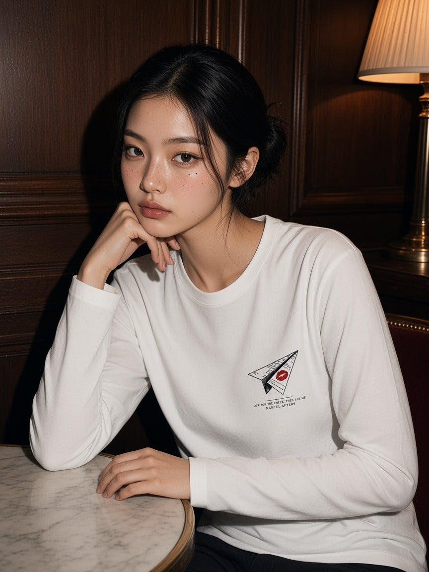 Woman in the Ask For The Check. Then Ask Me Heavyweight Long Sleeve T-Shirt in White in a New York hotel bar at night