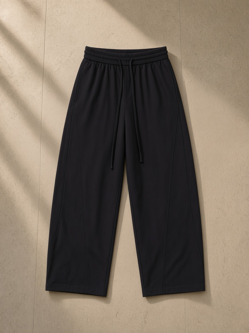 Wide Leg Drawstring Pants in Black, laid flat on pale limestone