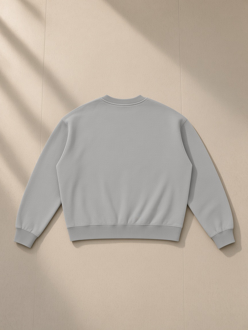 Boxy Vintage Washed Sweatshirt in Light Gray, laid flat on pale limestone, back view