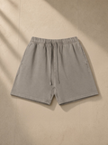 Vintage Wash Cotton Shorts in Light Coffee, laid flat on pale limestone