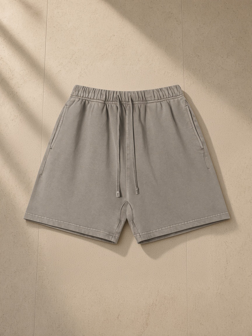 Vintage Wash Cotton Shorts in Light Coffee, laid flat on pale limestone