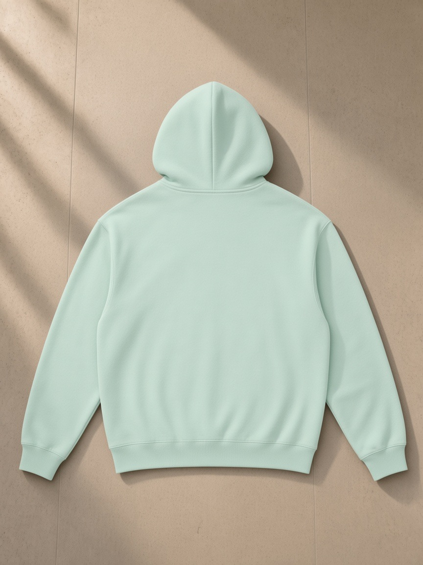 Unisex heavyweight hoodie in Water Blue, laid flat on pale limestone, back view