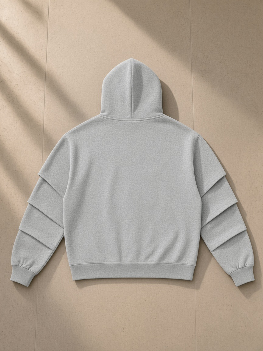 Unisex heavyweight ruched sleeves hoodie in Flower Gray, laid flat on pale limestone, back view