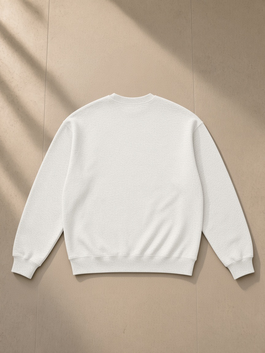 Oversized drop shoulder crewneck sweatshirt in Oat Gray, laid flat on pale limestone, back view