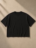 Unisex washed rolled hem half sleeve t-shirt in Black, front view on white. Marcel Afters