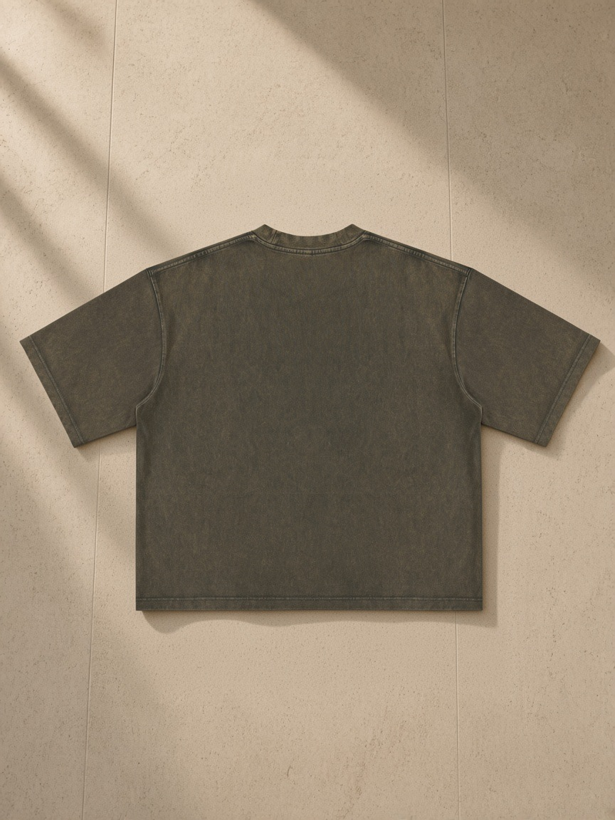 Women's Heavyweight Mineral Wash Boxy T-Shirt in Brown, laid flat on pale limestone, back view