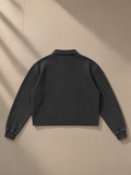 Mineral Wash Pullover Sweatshirt in Black, laid flat on pale limestone, back view