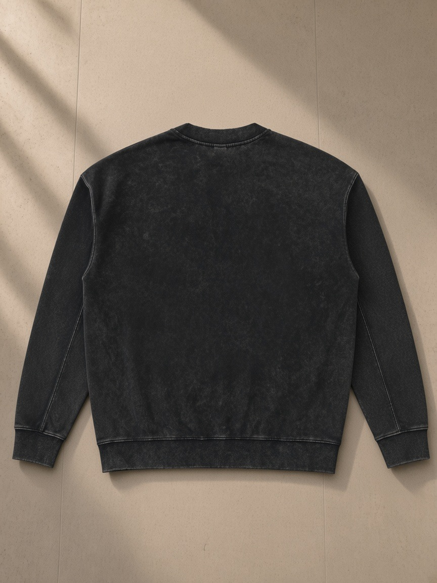 Drop Shoulder Crewneck Sweatshirt in Washed Black, laid flat on pale limestone, back view