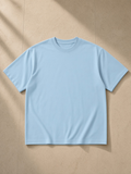 Unisex Quick-Dry Relaxed Fit T-Shirt in Sky Blue, laid flat on pale limestone