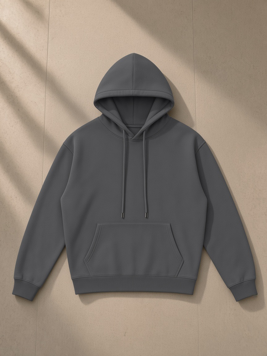 Streetwear Fleece Hoodie in Dark Gray, laid flat on pale limestone