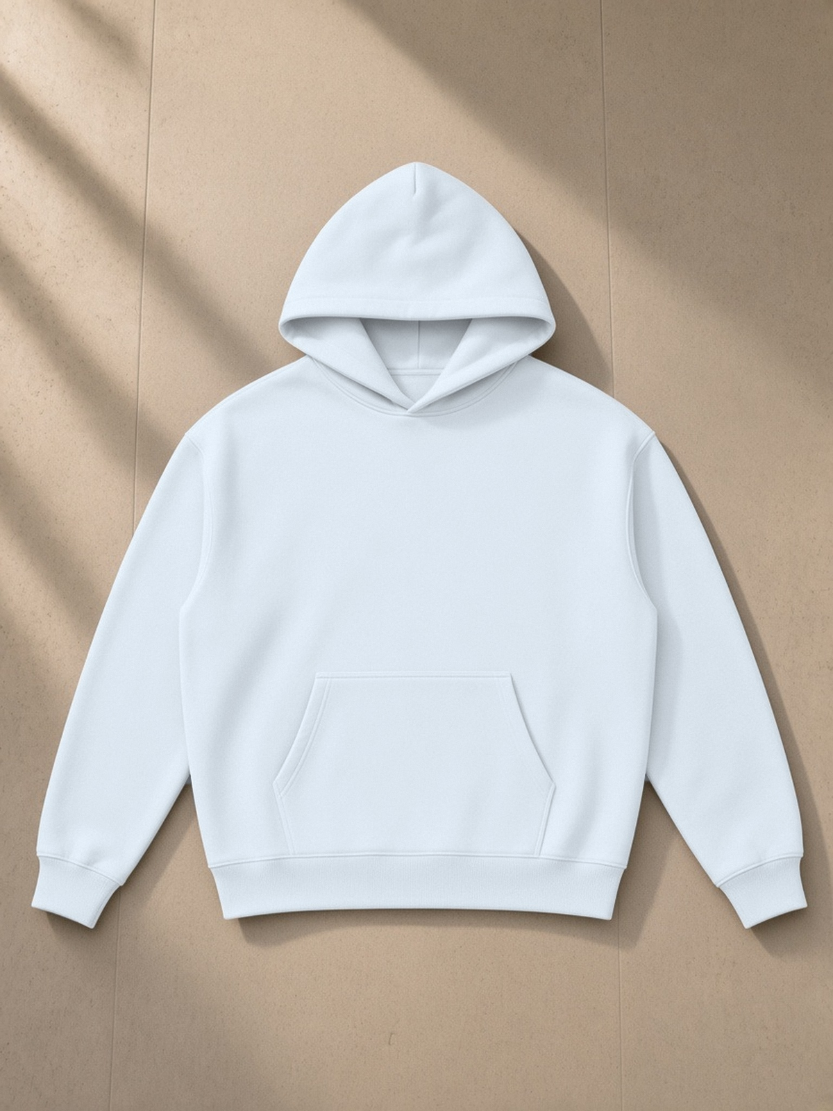 Essential Heavyweight Hoodie in Blue, laid flat on pale limestone, front.