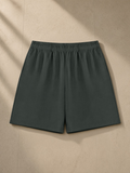 Cotton Shorts in Dark Gray, laid flat on pale limestone