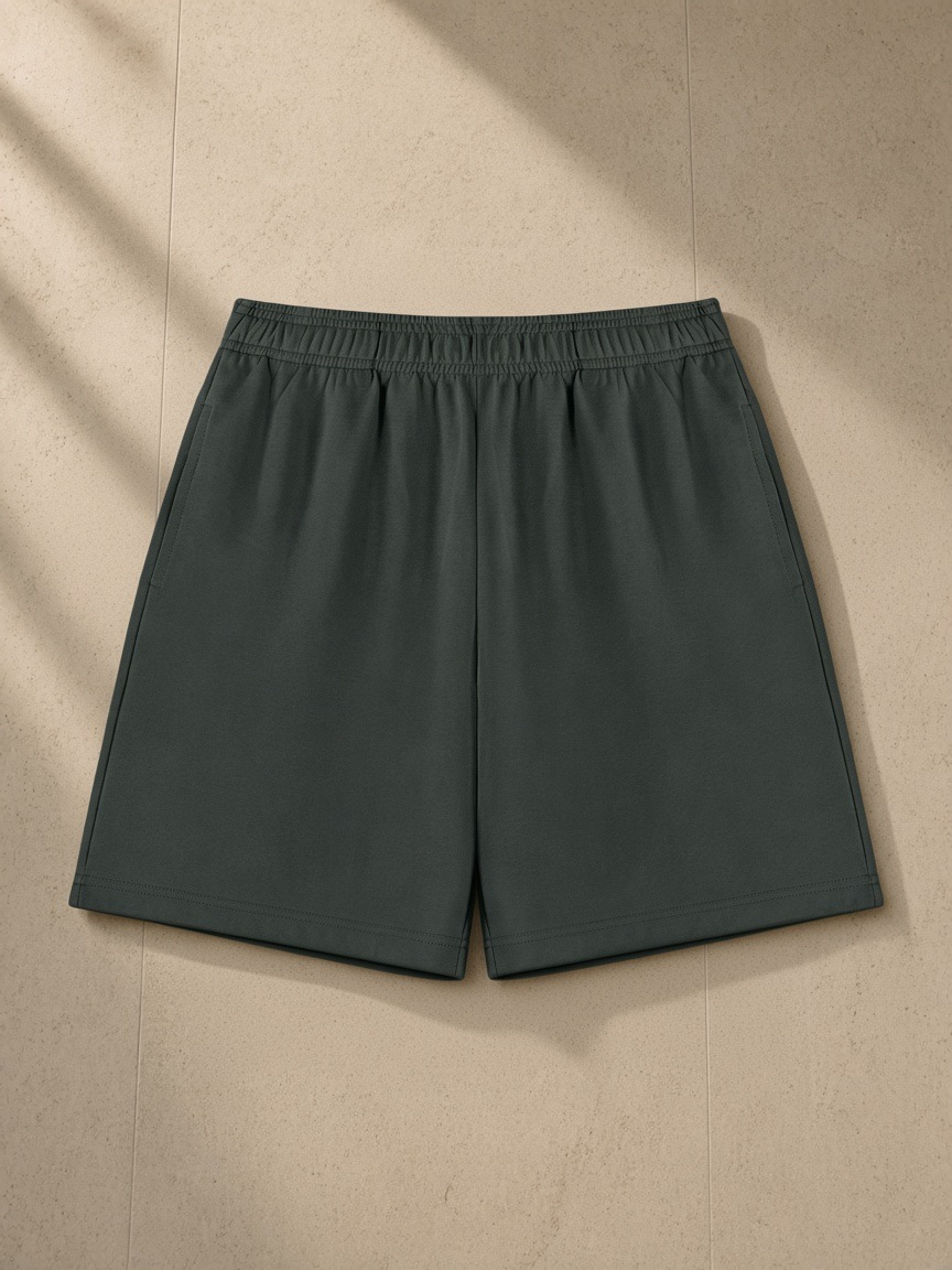 Cotton Shorts in Dark Gray, laid flat on pale limestone