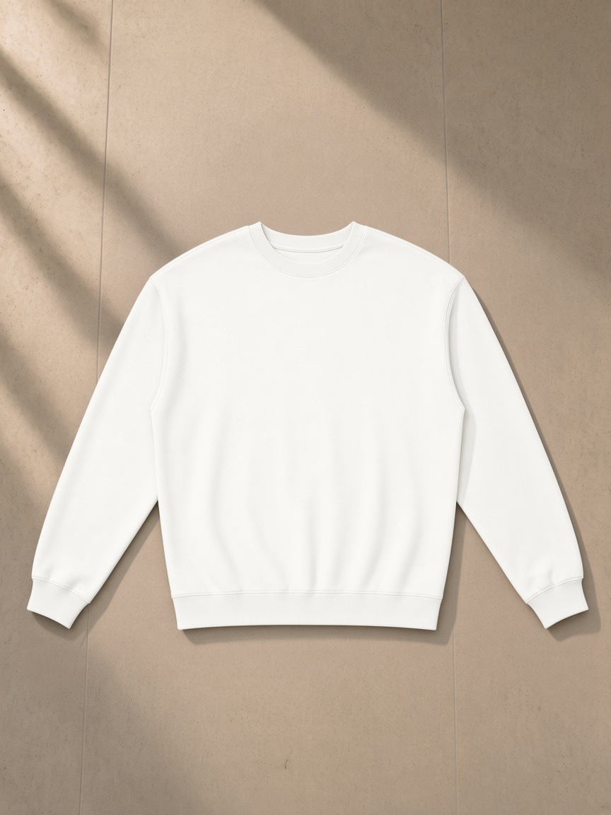 Loose Crewneck Sweatshirt in White, laid flat on pale limestone, front.