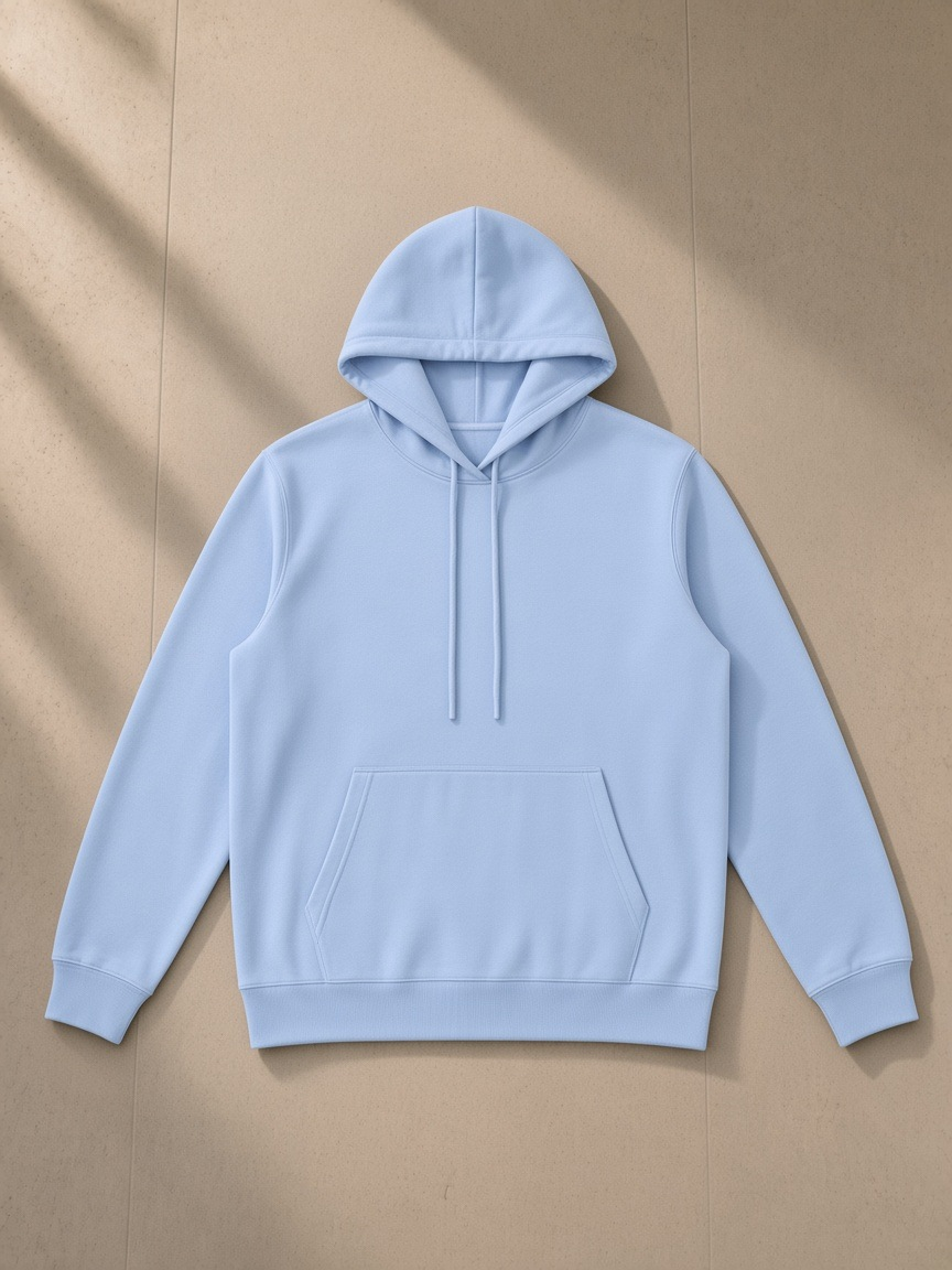 Essential oversized hoodie in Sky Blue, laid flat on pale limestone
