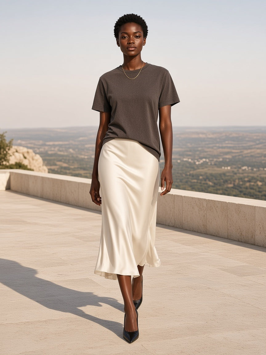 Woman in the Marcel Afters Bamboo Slub Snow Washed T-Shirt in Coffee on a stone resort terrace above a valley