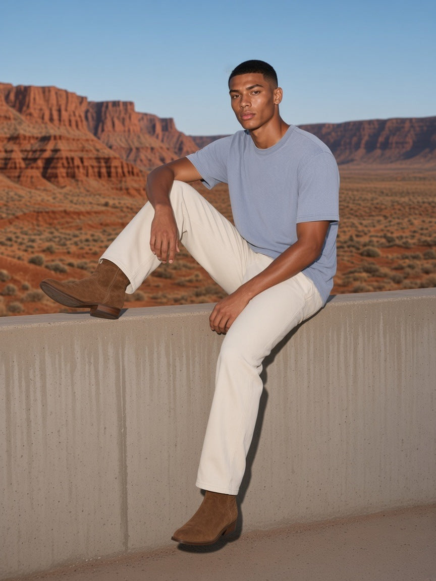 Man in the Bamboo Slub Snow Washed T-Shirt in Lake Ice Blue walking a desert-resort terrace in Utah in the morning