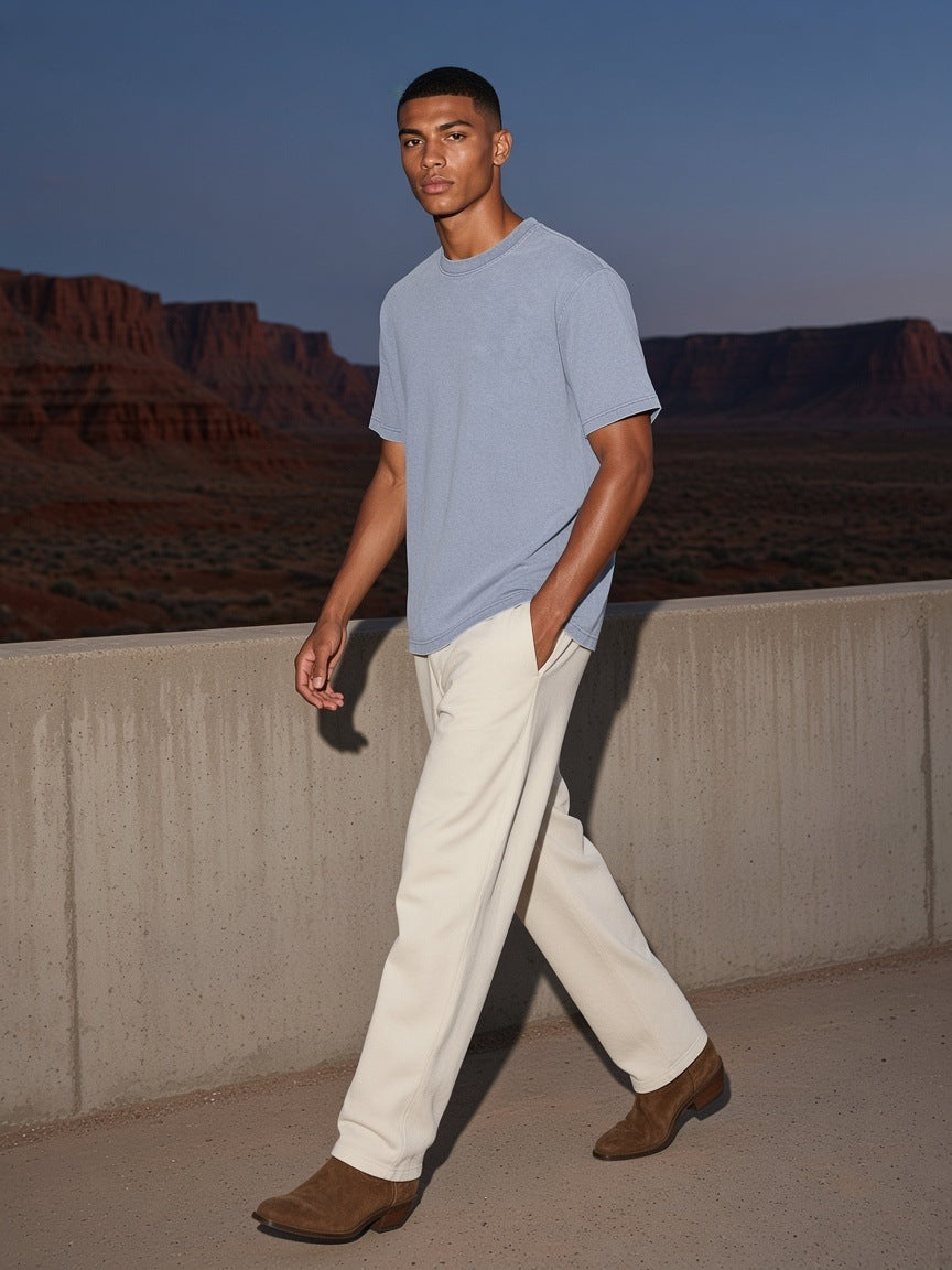 Man in the Bamboo Slub Snow Washed T-Shirt in Lake Ice Blue walking a desert-resort terrace in Utah at night
