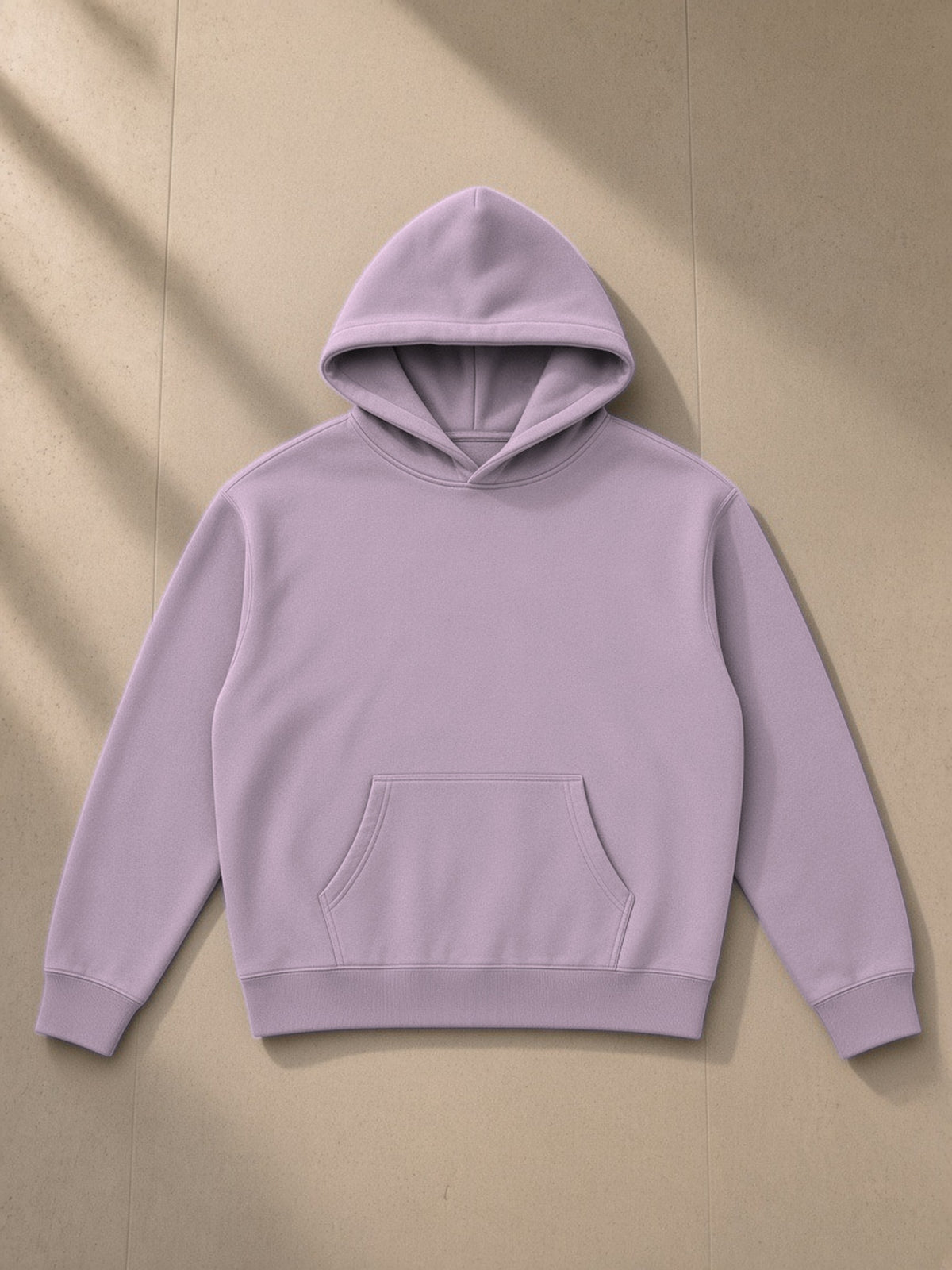 Oversize fleeced hoodie in Dark Purple, laid flat on pale limestone