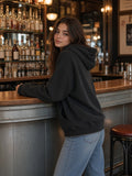 Woman in the Vintage Wash Raw Edge Boxy Hoodie in Black, model front