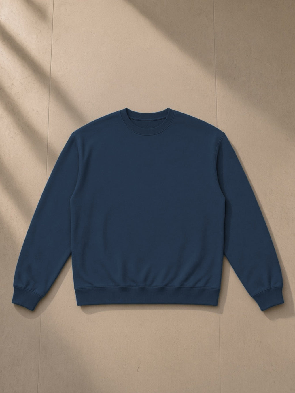 Heavyweight Crewneck Sweatshirt in Navy Blue, laid flat on pale limestone, front view