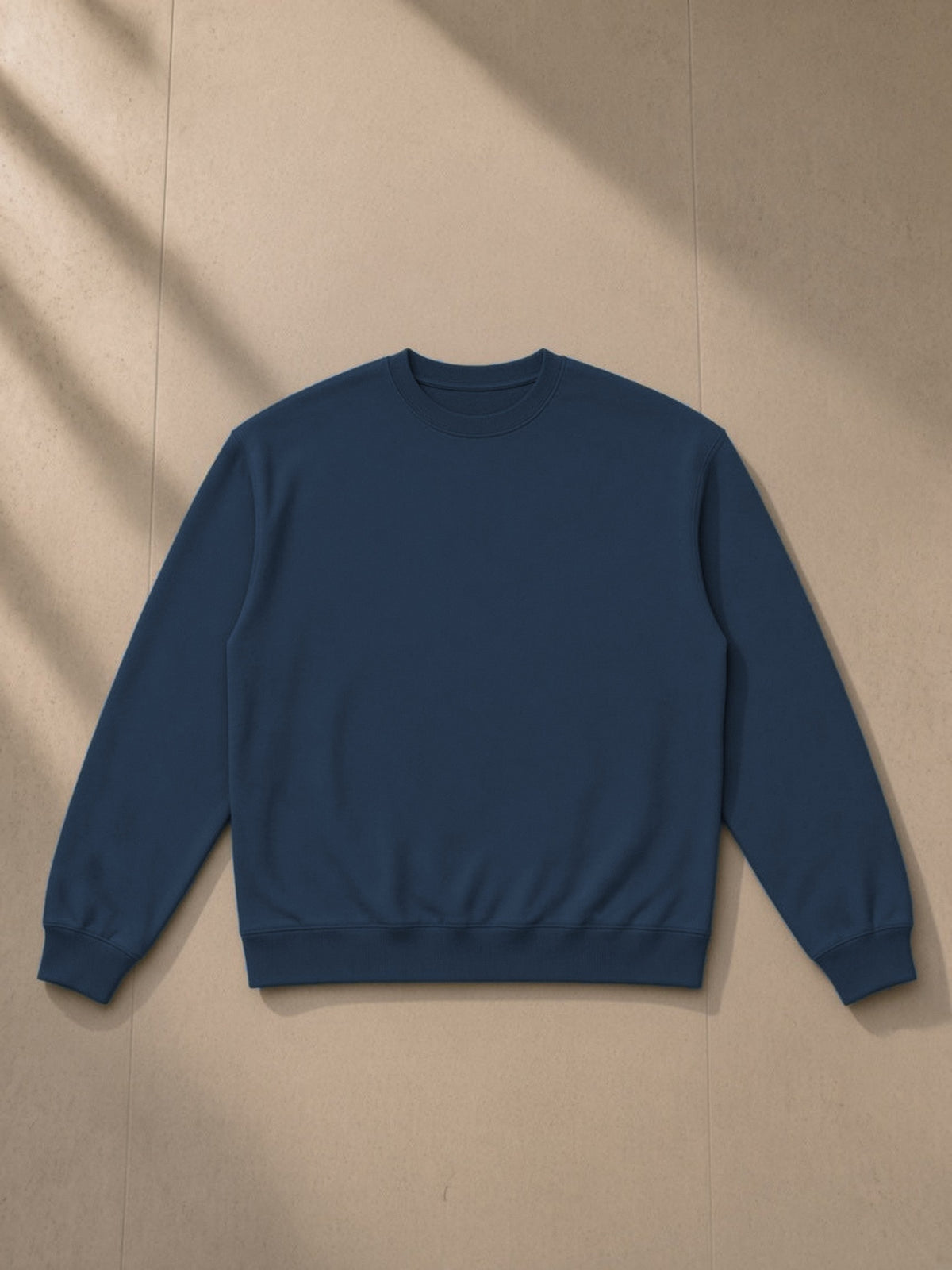 Heavyweight Crewneck Sweatshirt in Navy Blue, laid flat on pale limestone, front view